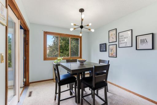 Dining area with large window overlooking the yard, bringing in plenty of natural light.