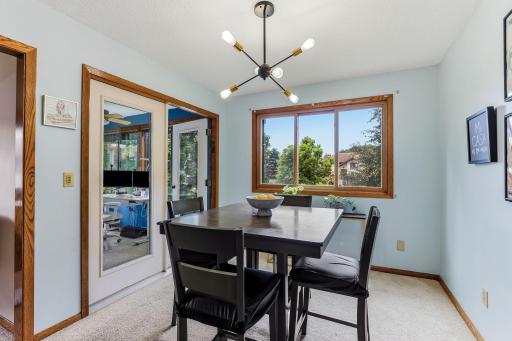 The dining room flows seamlessly from the kitchen and provides easy access to the 3-season porch through the double-sided glass door. The seller uses this space year-round with a portable fireplace that is not included.
