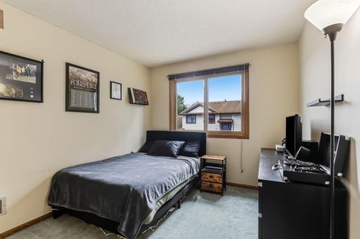 Bedroom with a large window for natural light and neighborhood views.