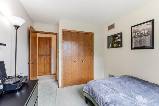 Secondary bedroom with double closet doors and neutral finishes.