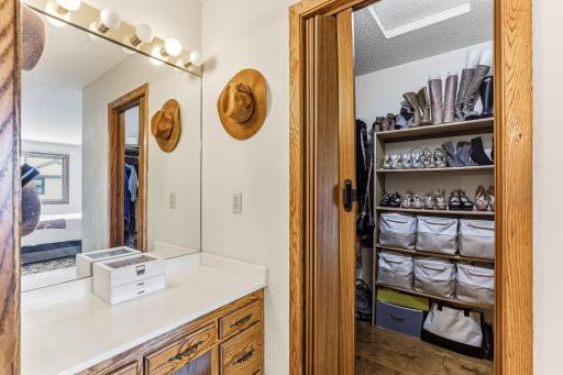 Primary suite vanity area and a walk-in closet offering exceptional storage and organization.
