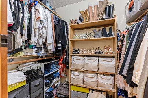 Walk-in closet with built-in shelving, hanging space, and dedicated shoe storage. Thoughtfully organized to maximize storage and keep clothing, accessories, and seasonal items neatly arranged.
