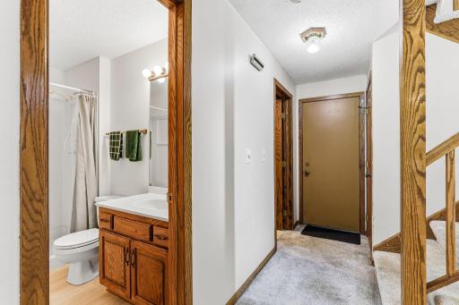 Lower-level landing providing convenient access to the 3/4 bath, utility room, and attached garage.