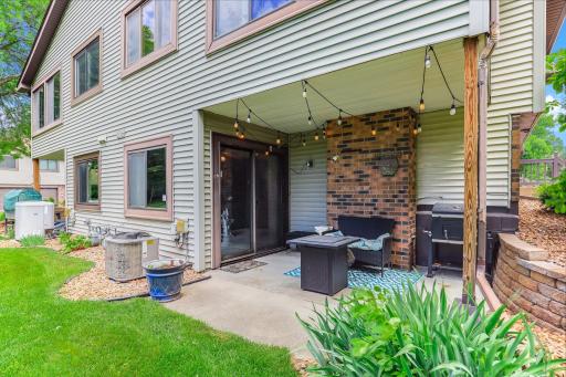 Covered patio with brick accents and a sheltered seating area, perfect for relaxing or entertaining.