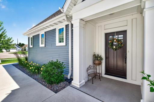 Beautiful landscaping and flowers lead to the front door.