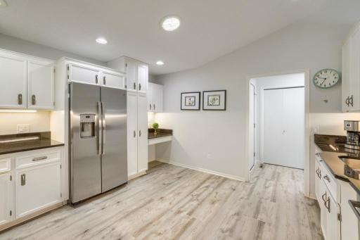 Kitchen is adjacent to laundry room and garage. Easy maintenance flooring and abundant cabinet & counter space.