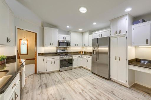 Lovely kitchen with abundant cabinet & pantry space. Room for a table if desired.