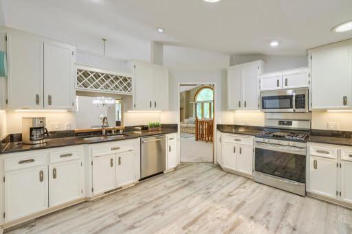 Updated and spacious kitchen is quite large! Room for an eat-in table if desired, granite counters, abundant cabinet and counter space, stainless appliances. Cut-out over sink leads into dining room.