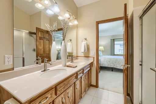 Main floor primary bedroom bathroom with dual vanities, separate shower and tub.