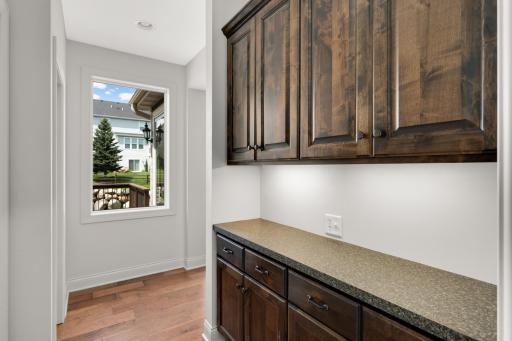 Mudroom behind the kitchen has storage space, a drop zone and a walk in closet.