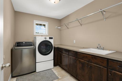 Upper level laundry with folding counter and laundry sink!