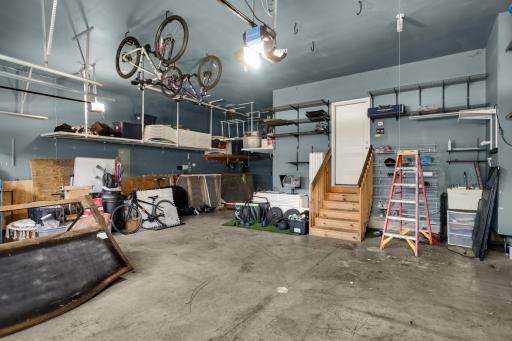 Huge 4 car garage with tall ceilings. Perfect to store whatever you need! Has a great storage system with an electric pull system.