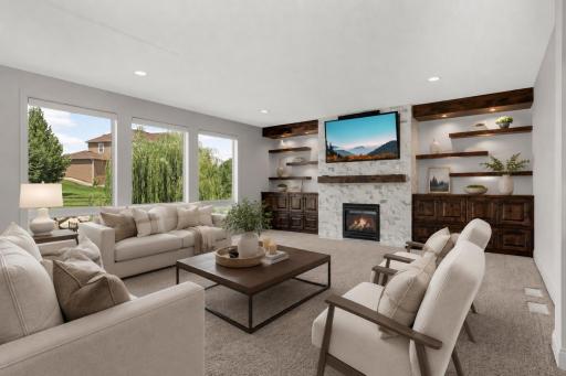 Spacious living room with tall ceilings. Nice built ins and gas fireplace (virtually staged)
