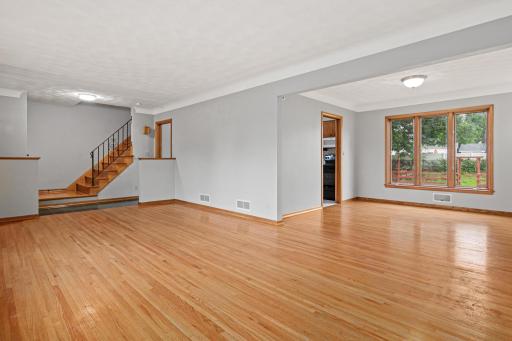 The living room flows into a separate dining room, which is connected to the kitchen.