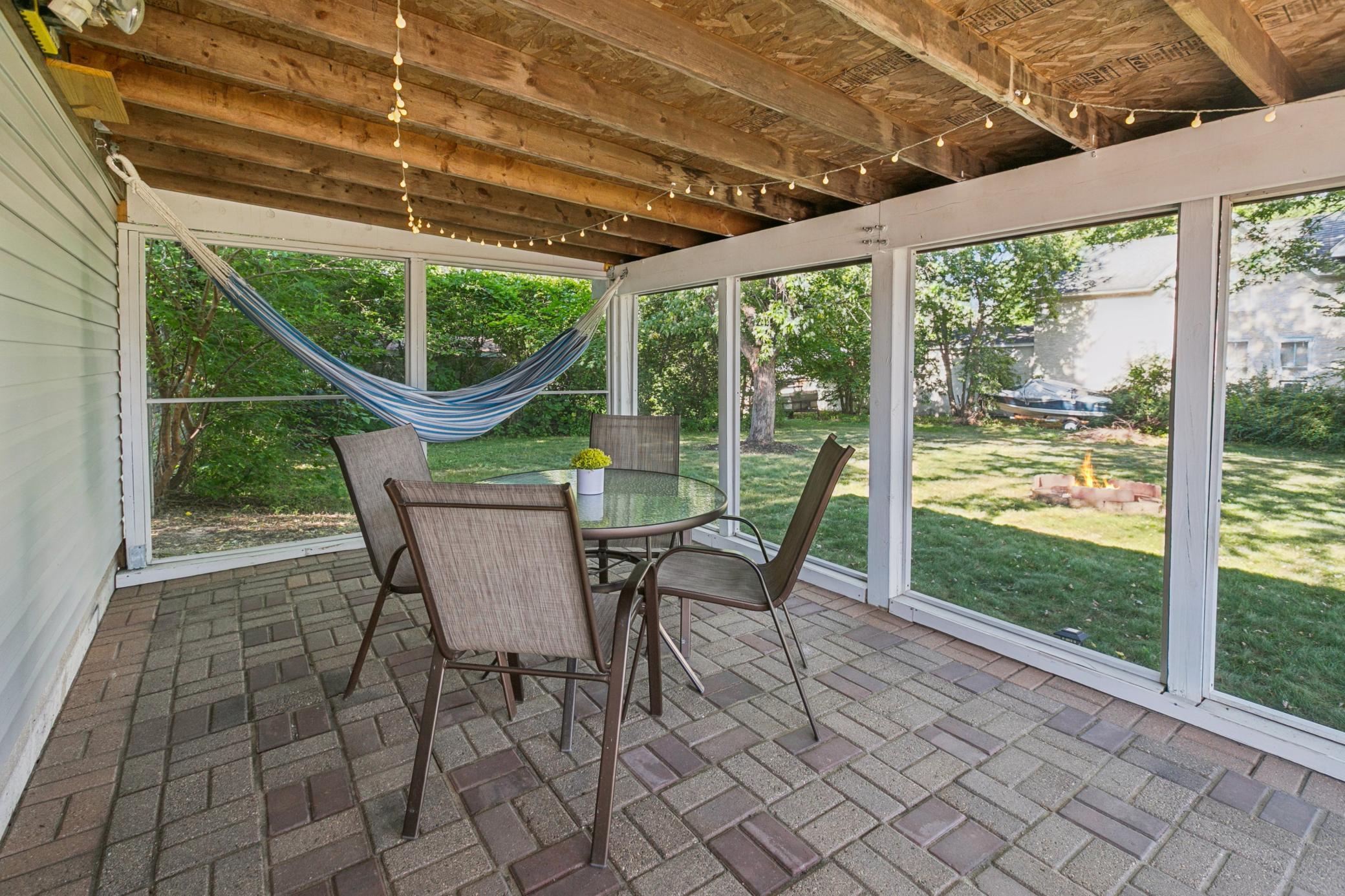 Current sellers installed screening to make this a cool, shaded space to enjoy from Spring to Fall. Mounted TV and lights will stay!