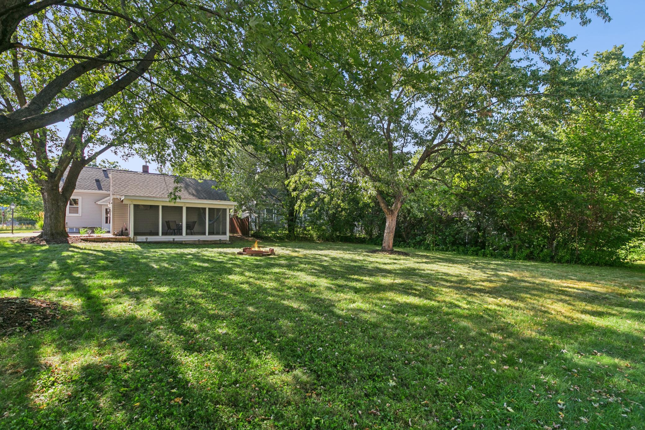 Level and easy to mow and maintain, this yard is ideal for outdoor entertainment, games. or gardening. (shade loving plants will love it!!)
