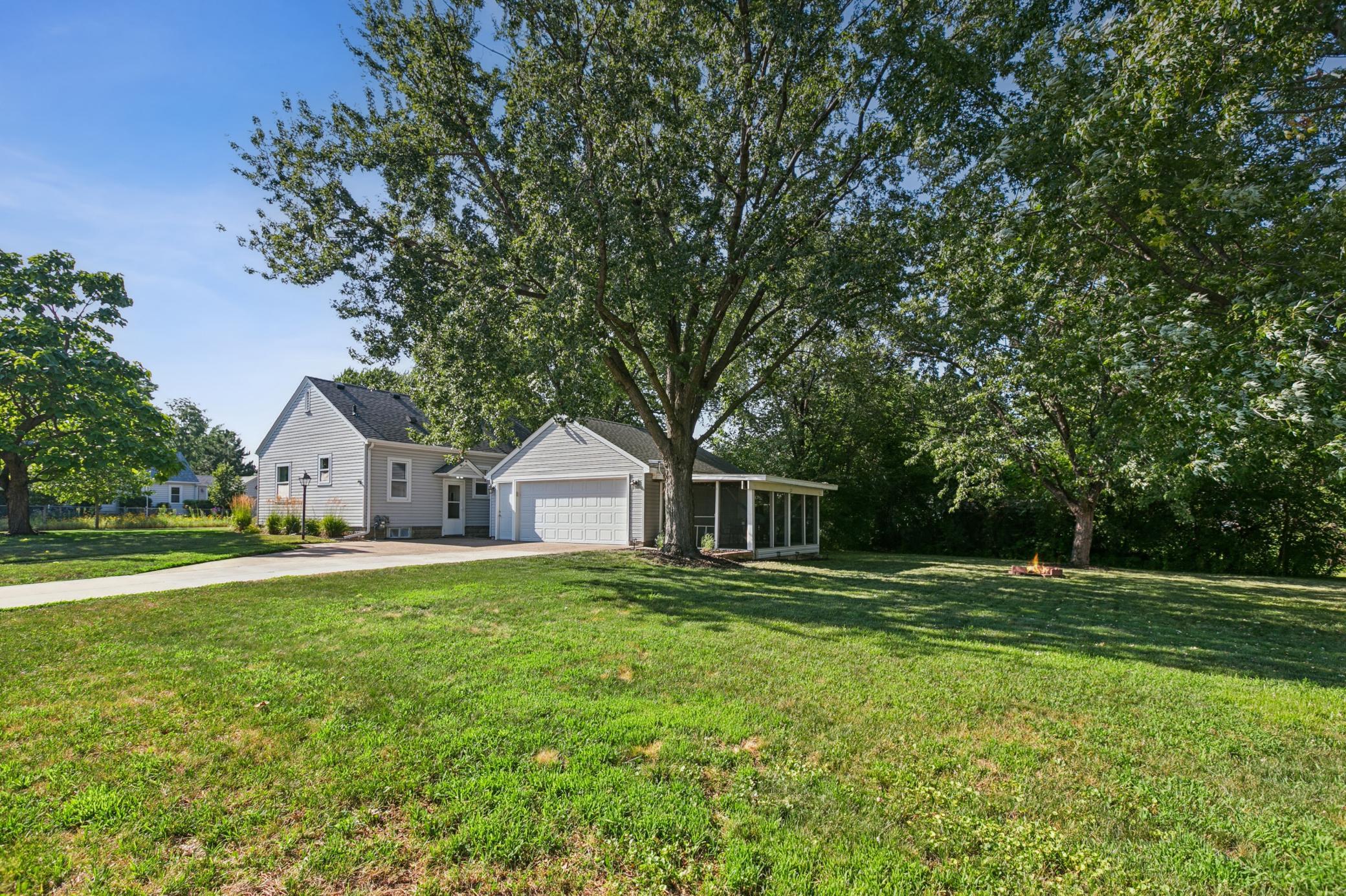 Corner lot measures over a third acre (WOW) with mature trees providing wonderful shade and privacy. (Note; the lot extends beyond the row of bushes on the right and includes a storage space and the shed.