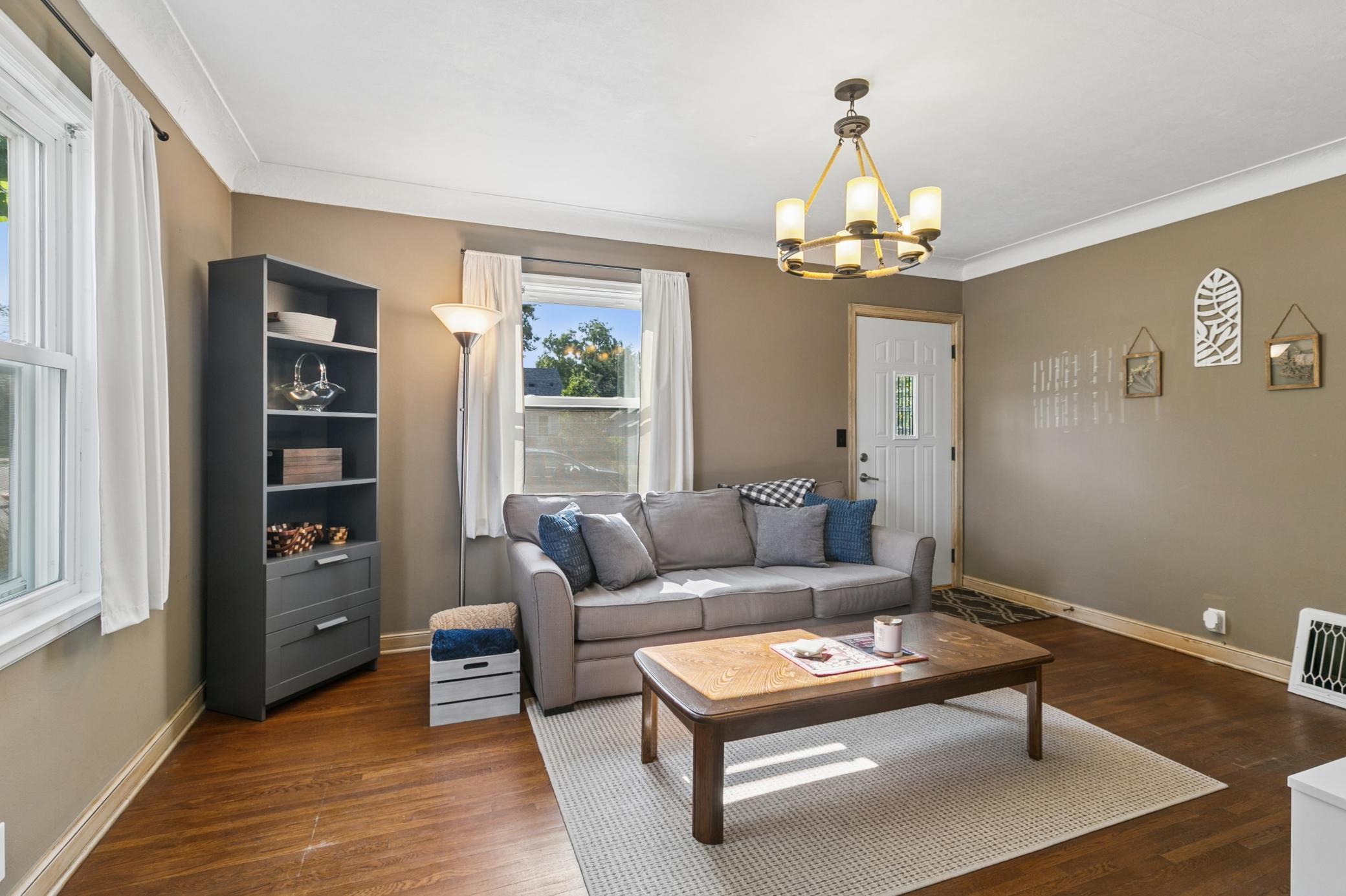Gleaming hardwoods and lots of nature light floods the living room with warmth. The coved ceiling adds character.