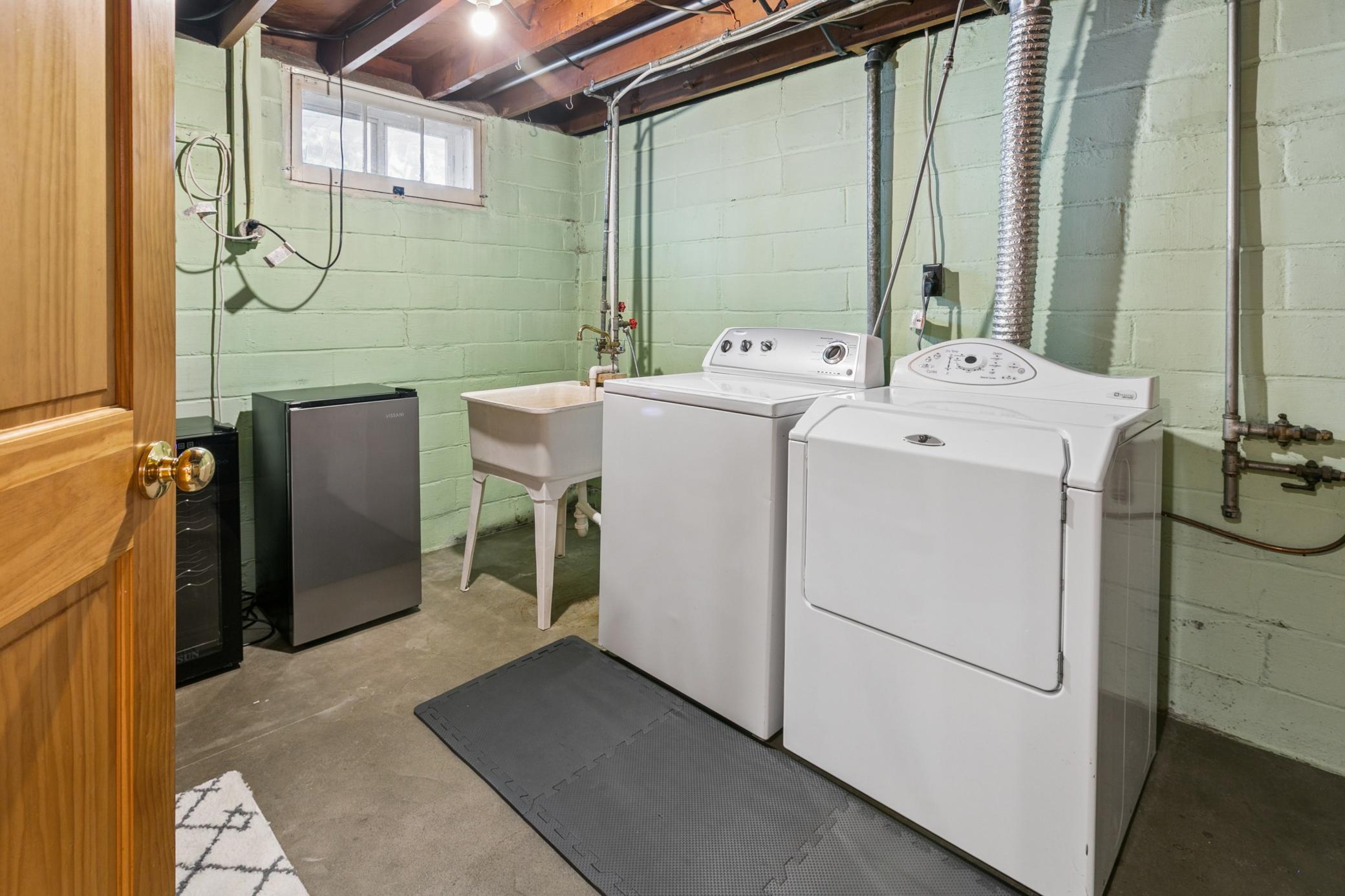 Bright and clean, the laundry room includes a utility sink for easy home project cleanups. More space for folding and storage. (beverage coolers not included :))