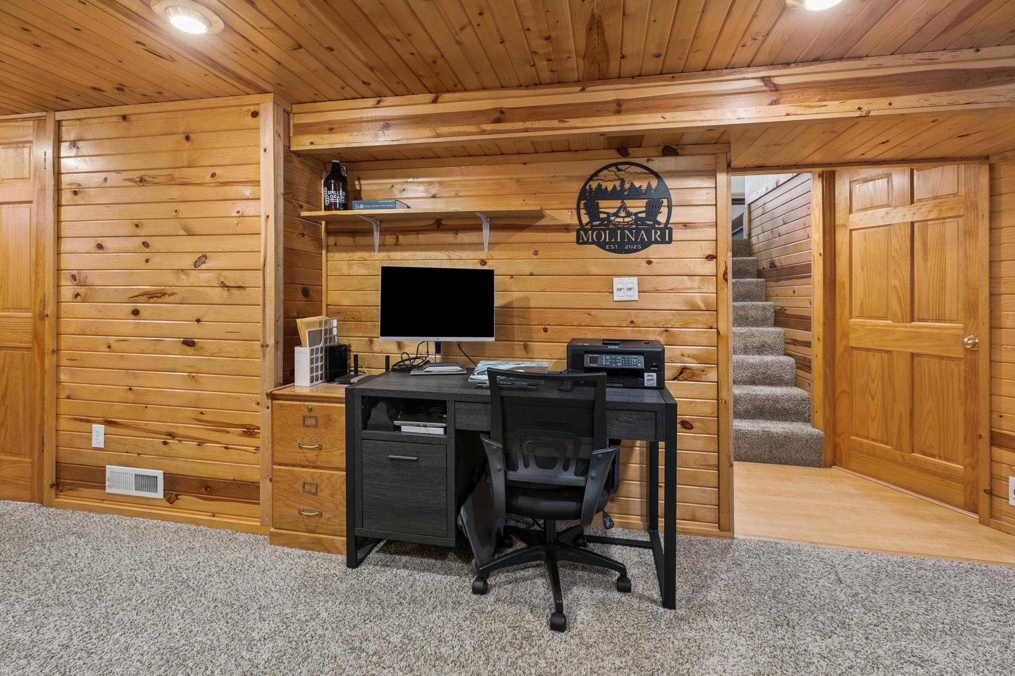 Recessed lighting and daylight windows provide a brightness and warmth to this space, currently used as a home office and family room.