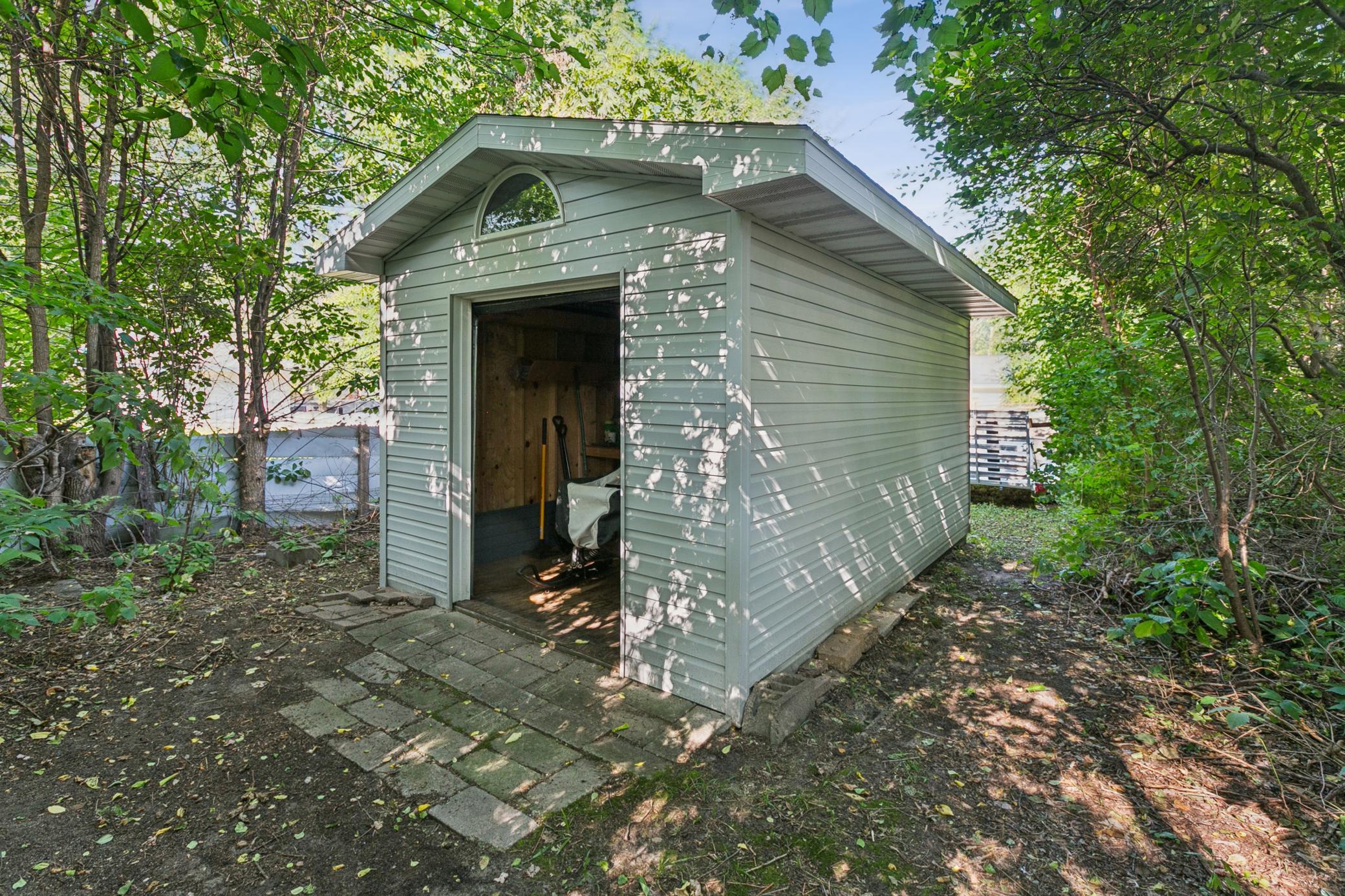 Tucked behind the row of hedges is a private space for the shed and storage (note trailer). Storage shed measures 17 x10 and has ample space to store recreational toys or the necessary yard tools. Roof replaced 2017.
