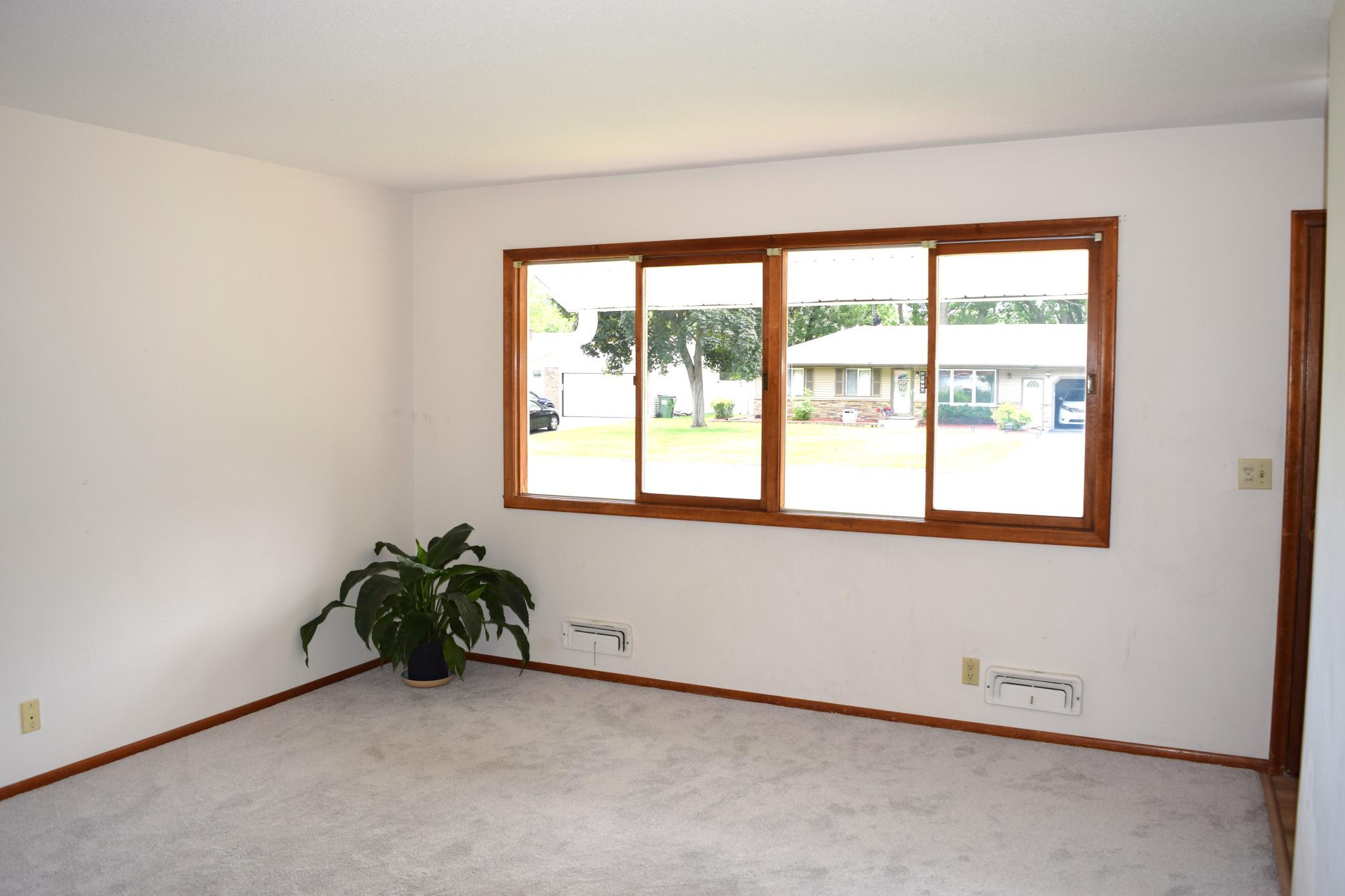 The main floor fills with natural light, the living room boasts a wall of windows overlooking the front yard!