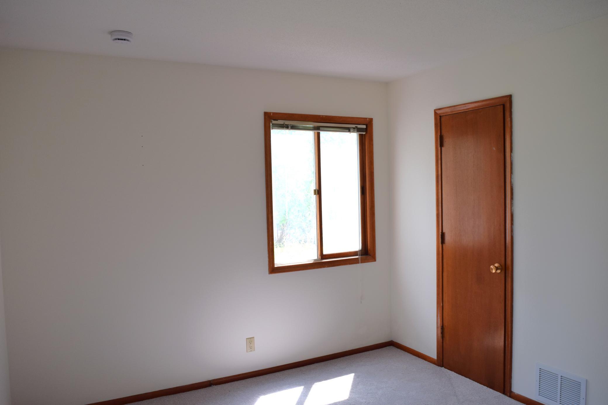 The second of two large windows in the primary bedroom and the closet.