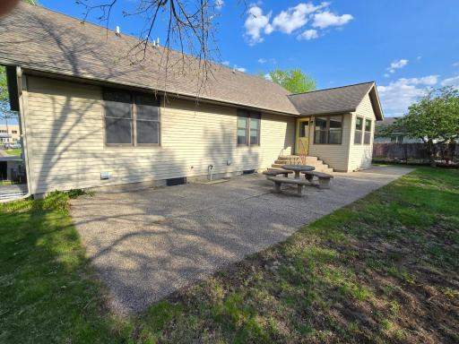 Large, concrete patio in back of home. Concrete table and benches as well!