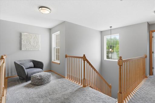 Head upstairs to a nice loft area that is perfect for a reading nook or even can fit a desk for an office area. The owners also replaced all of the carpet on the stairs and upper-level loft, hallway and bedrooms.