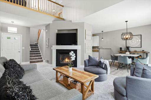 Upon entering the home, you are greeted by this large two-story living room that features a gas fireplace.
