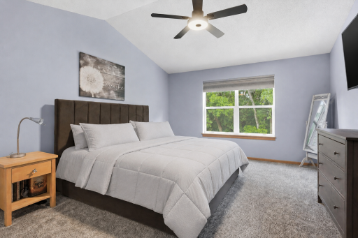 The home offers two bedrooms including this big primary bedroom with two closets! This room has a vaulted ceiling, ceiling fan and can accommodate plenty of furniture.