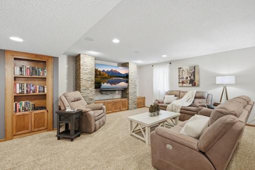 Handsome Lower Level Family Room - Natural Stone Feature Wall With Built-Ins