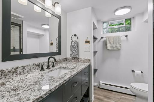 Recently remodeled lower level 3/4 bathroom with elegant updates, stone/tile work.