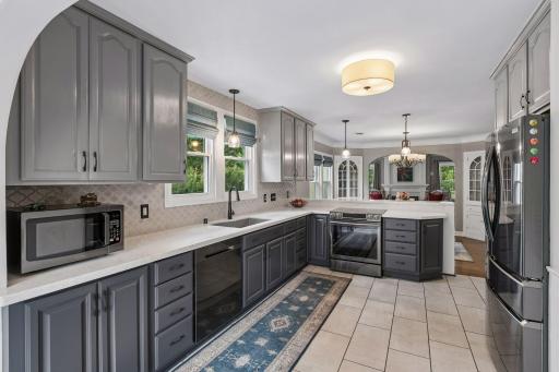 Glamorous kitchen is a delight to behold and to cook in, with stone tile accents and high-quality finishes.
