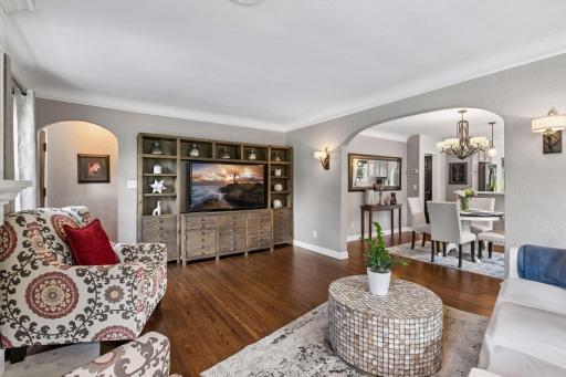 View of front door entryway to the left, and view of living/dining/kitchen and the easy flow of the main floor.