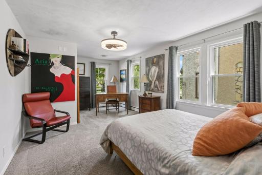 One of two main floor bedrooms, with modern lighting, updated windows, extra space for a desk or exercise nook.