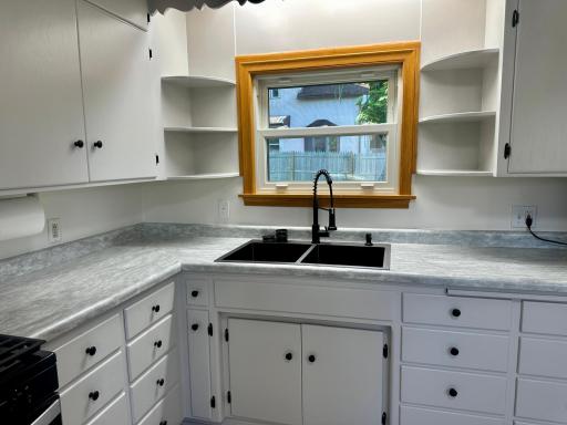 Professionally Painted Cabinetry, New Counter Tops & New Double Sink. Newer Kitchen Window.