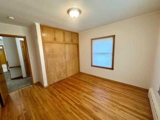 Bedroom 1 - Newer Windows PLUS Classic Oak Flooring. Large Double Closet with Upper Cabinets Equals More Storage Room.