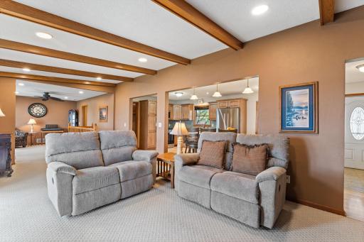 Beautiful wood beams accents the living room, vaulted ceilings. Kitchen and living room create a fabulous open floor plan.
