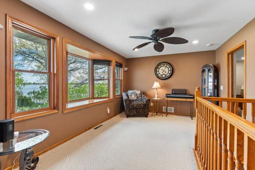 Incredible flex space showcasing panoramic lake views through a wall of windows. Whether you envision a cozy sitting area, formal dining room, reading nook, or creative retreat, this versatile space is ready to fit your lifestyle.