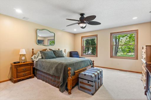 Your main-level, primary bedroom suite awaits! Abundance of windows, neutral decor. Offers primary bathroom and walk-in closet.