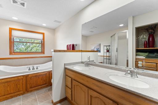 Gorgeous primary bathroom with oversized tub, double sinks and beautiful countertops and tiled floors.