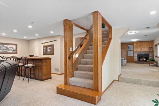 No detail was overlooked. The open staircase and exceptional craftsmanship lead to a beautifully finished lower level featuring expansive gathering spaces, a recreation area, and flexible rooms designed to fit your lifestyle.