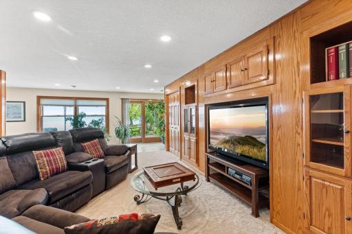 Fabulous built-ins and storage in this cozy family room space. Neutral paint and carpeting throughout.