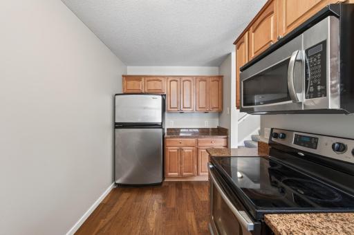 Efficient kitchen layout offers generous cabinet storage, ample counter space, and easy access to the dining area.