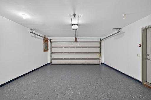 Spacious attached garage features an epoxy floor finish and room for storage, tools, or outdoor gear.