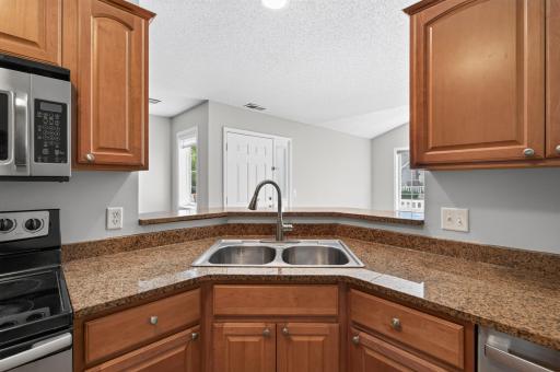Corner sink with views into the living space creates an open, connected feel while preparing meals.