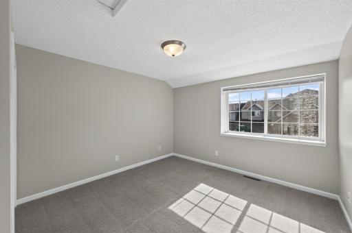 Spacious bedroom with large picture window.
