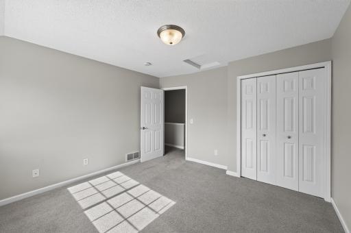Bright and inviting bedroom featuring neutral finishes.