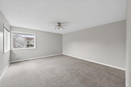 Expansive primary suite offers plenty of space for a sitting area or additional furnishings.
